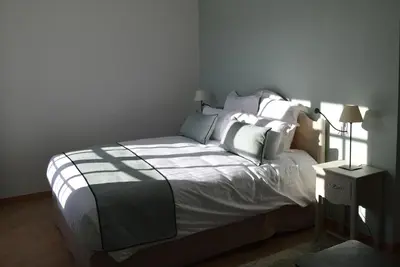 a bedroom with a bed with white sheets and pillows at Le Domaine d'Euphony in Monteux