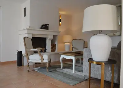 a living room with two chairs and a fireplace at Le Domaine d'Euphony in Monteux