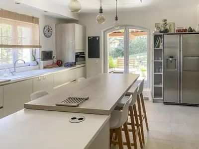 a kitchen with a large island with a counter top at Le Jardin des Chenes in Eyragues