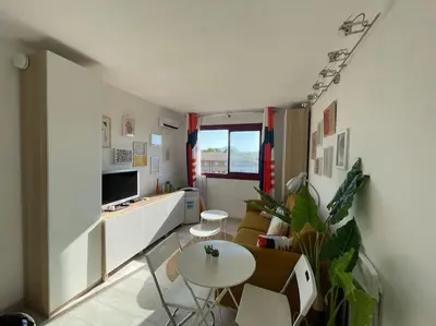a small living room with a table and a couch at Charmant Studio à 5 min d’Aix en Provence in Aix-en-Provence