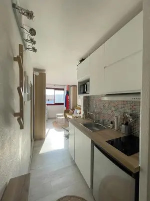 a kitchen with white cabinets and a counter top at Charmant Studio à 5 min d’Aix en Provence in Aix-en-Provence