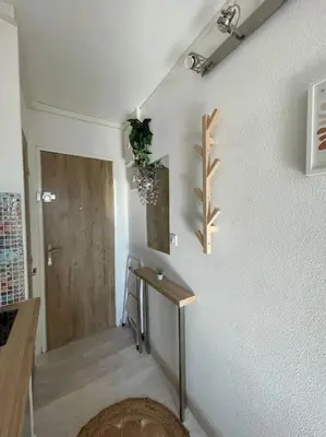 a room with a hallway with a table and a door at Charmant Studio à 5 min d’Aix en Provence in Aix-en-Provence