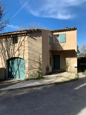 a house with a garage on a street at Maison de charme à Lourmarin in Lourmarin