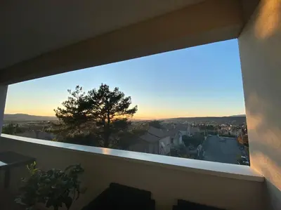 a view of a city from a balcony at Beau Duplex climatisé T3 vue panoramique Luberon in Pertuis