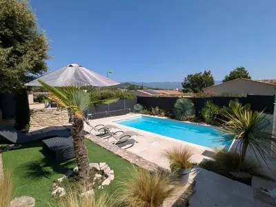 a swimming pool with a palm tree and an umbrella at Gîte Le Bosquet - Au cœur du Luberon in Apt