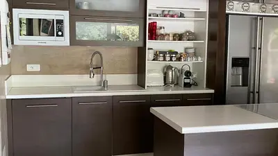 a kitchen with a sink and a refrigerator at Maison AdriAnna in Vedène