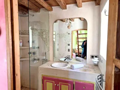 a person taking a picture of a bathroom with a sink at Villa élégante à Lambesc avec spa in Lambesc
