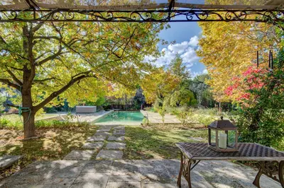 a table with a lamp on it in a garden at Villa élégante à Lambesc avec spa in Lambesc