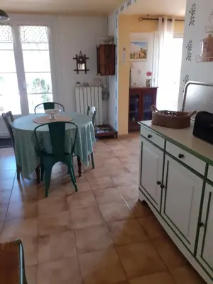 a kitchen with a table with a green table cloth at Gite Bienvenue Lili in Châteauneuf-de-Gadagne