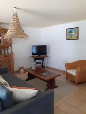 a living room with a couch and a coffee table at Gite Bienvenue Lili in Châteauneuf-de-Gadagne