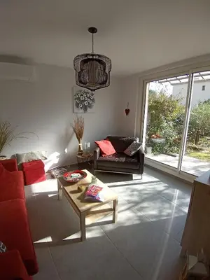 a living room with a couch and a table at Le charme de Landra in Pernes-les-Fontaines