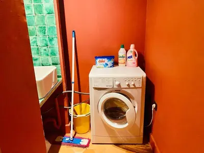 a laundry room with a washing machine and a washer at Maison des Arts Aix en Provence Apartment in Aix-en-Provence