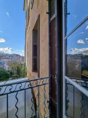 a view from a balcony of a building with a window at Maison des Arts Aix en Provence Apartment in Aix-en-Provence