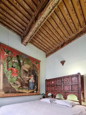 a bedroom with a large painting on the wall at Maison des Arts Aix en Provence Apartment in Aix-en-Provence