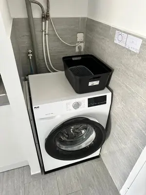 a washing machine with a black box on top of it at Appartement cosy avec cour privée & terrasse Calme idéal couples familles in Cavaillon