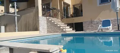 a house with a swimming pool with a chair and stairs at Villa avec vue in Sainte-Tulle