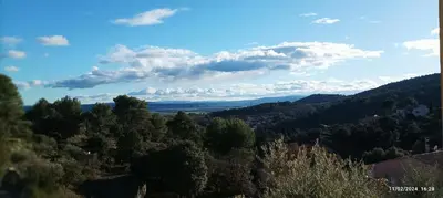 a view of a valley with trees and clouds at Villa avec vue in Sainte-Tulle