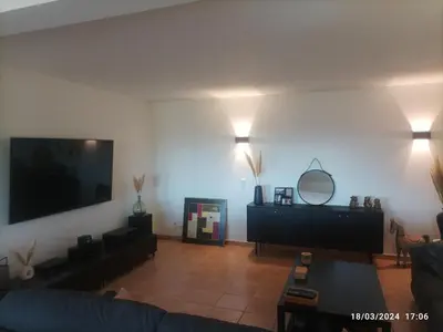 a living room with a couch and a flat screen tv at Villa avec vue in Sainte-Tulle