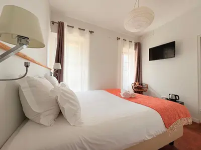 a bedroom with a large white bed with white pillows at Domaine Gao in Aix-en-Provence