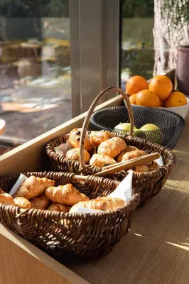 two baskets of bread and oranges on a table at Domaine Gao in Aix-en-Provence