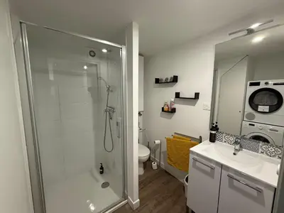 a bathroom with a shower and a toilet and a sink at L'Amandier - Joli appartement T3 neuf centre ville à 2 pas de la Rotonde Mirabeau et des Allées Provençales in Aix-en-Provence