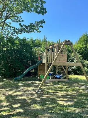 a playground with a slide in a yard at La provence avec piscine privative en campagne in Pernes-les-Fontaines
