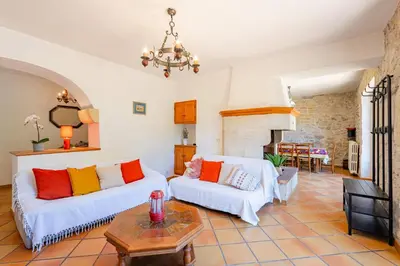 a living room with two white couches and a table at La Maison de Sophie in Châteauneuf-de-Gadagne