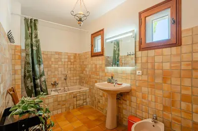 a bathroom with a sink and a tub and a toilet at La Maison de Sophie in Châteauneuf-de-Gadagne