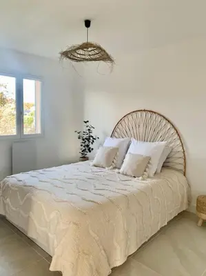 a bedroom with a large bed with white sheets and pillows at Provensa - love room avec balneo et terrasse avec vue in Pertuis