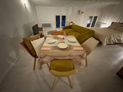 a living room with a table and a couch at Carpentras cosy& 3 voyageurs& in Carpentras