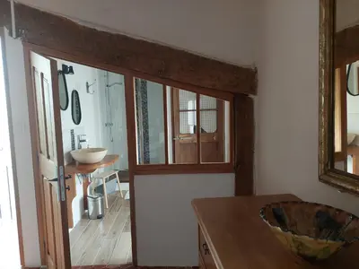 a kitchen with a door and a table and a mirror at LE GRAIN DE LAVANDE - Mont Ventoux in Sault-de-Vaucluse