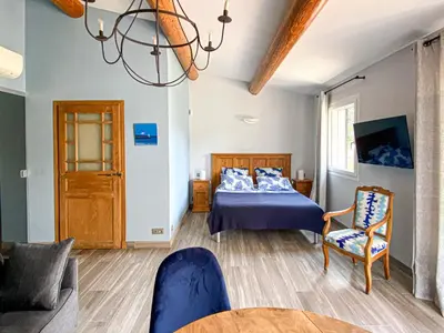 a bedroom with a bed and a couch and a table at la chamade grande chambre B&B indépendante in Ventabren
