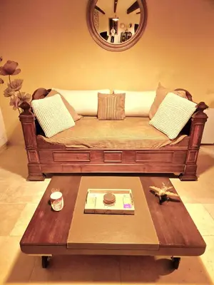 a living room with a couch and a table at Au Lys rose in LʼIsle-sur-la-Sorgue