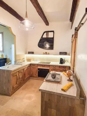 a kitchen with a sink and a counter top at Au Lys rose in LʼIsle-sur-la-Sorgue