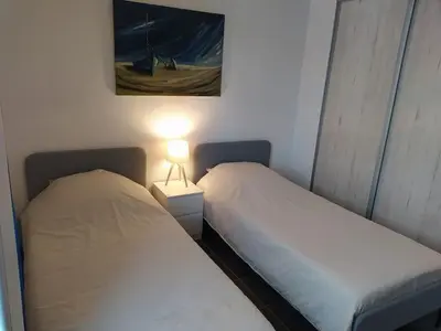 two beds in a room with a lamp and a painting at Maison en Provence in Entraigues-sur-la-Sorgue