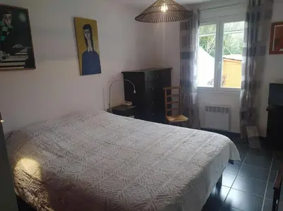 a bedroom with a bed and a window at Maison en Provence in Entraigues-sur-la-Sorgue