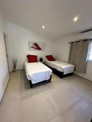 a bedroom with two beds and a window at Gîte des Pape in Bédoin