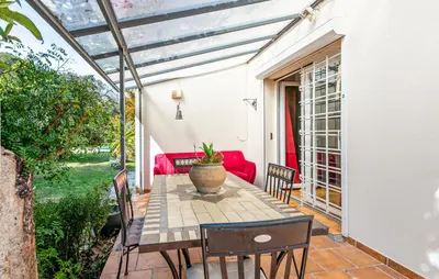 a patio with a table and chairs and a couch at Gorgeous Home In Miramas in Miramas