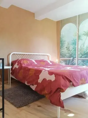 a bedroom with a bed with a floral blanket at Bedoin Mas PASEVE in Bédoin