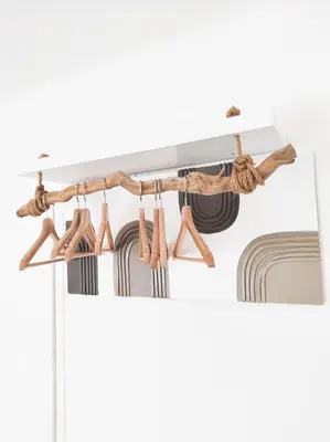 a room with a hanging rack of luggage at Le Cosy Valcros, design et confort in Aix-en-Provence