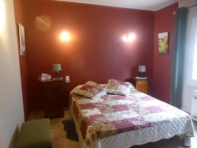 a bedroom with a bed with a quilt on it at 2 chambres au calme Villa Chrisma Provence in Orgon