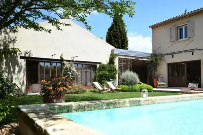 a house with a swimming pool in front of a house at Profitez de la quiétude en bord de rivière, à 5 min du centre ville in LʼIsle-sur-la-Sorgue
