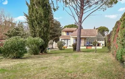 a house with a yard with trees and bushes at Stunning Home In Loriol-Du-Comtat in Loriol-du-Comtat