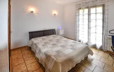 a bedroom with a bed and two windows at Stunning Home In Loriol-Du-Comtat in Loriol-du-Comtat
