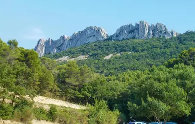 a mountain with cars parked in front of it at Stunning Home In Loriol-Du-Comtat in Loriol-du-Comtat