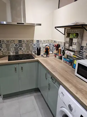 a kitchen with a counter top with a washer at la petite maison in Céreste