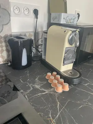 a kitchen counter with a coffee maker and a toaster at maison_du_sud_13140 in Miramas