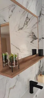 a mirror on a wall above a bathroom sink at maison_du_sud_13140 in Miramas