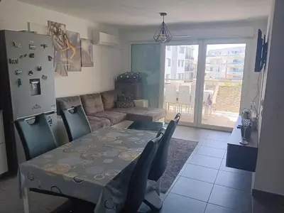 a living room with a table and a couch at MIRANEO in Miramas