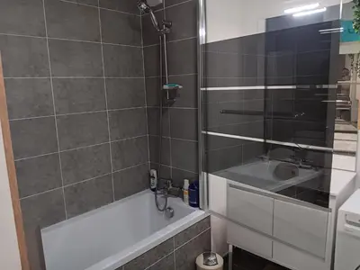 a bathroom with a shower and a tub and a sink at MIRANEO in Miramas